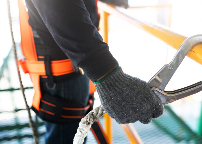 Construction worker wearing safety harness and safety line worki Safety.jpg